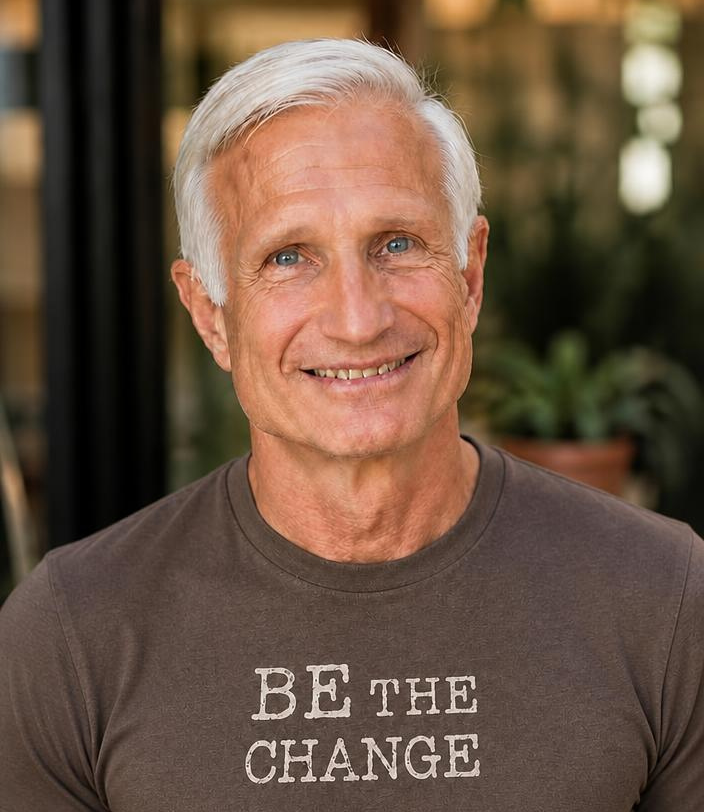 Portrait of Gary Tomchuk wearing a Be The Change shirt
